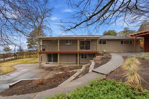 Back of property with brick siding and a patio area