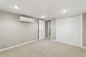 Unfurnished bedroom featuring light carpet, a closet, and recessed lighting