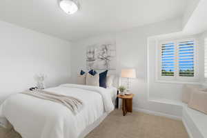 Carpeted bedroom with baseboards