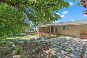 Back of property featuring a patio and brick siding