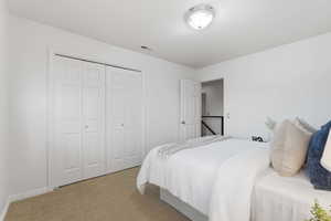 Bedroom with carpet and a closet
