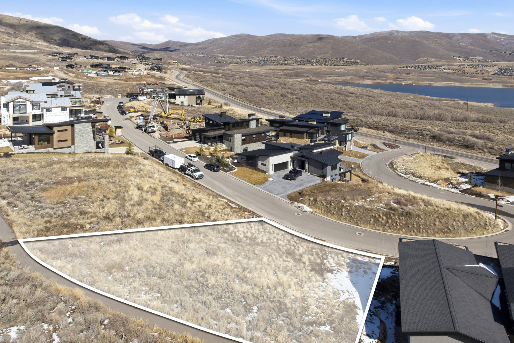 Aerial view of property's location with a mountain backdrop and nearby suburban area