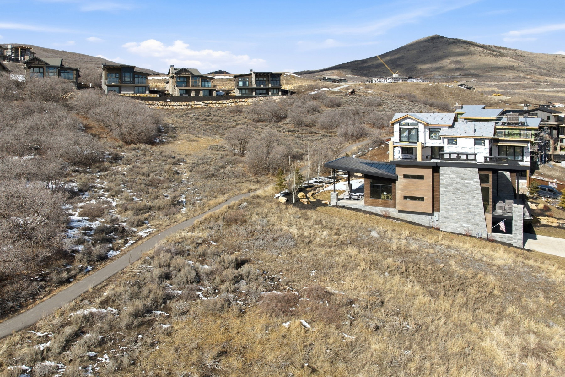 View of mountain backdrop featuring nearby suburban area
