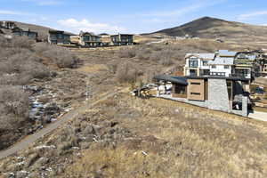 View of mountain backdrop featuring nearby suburban area