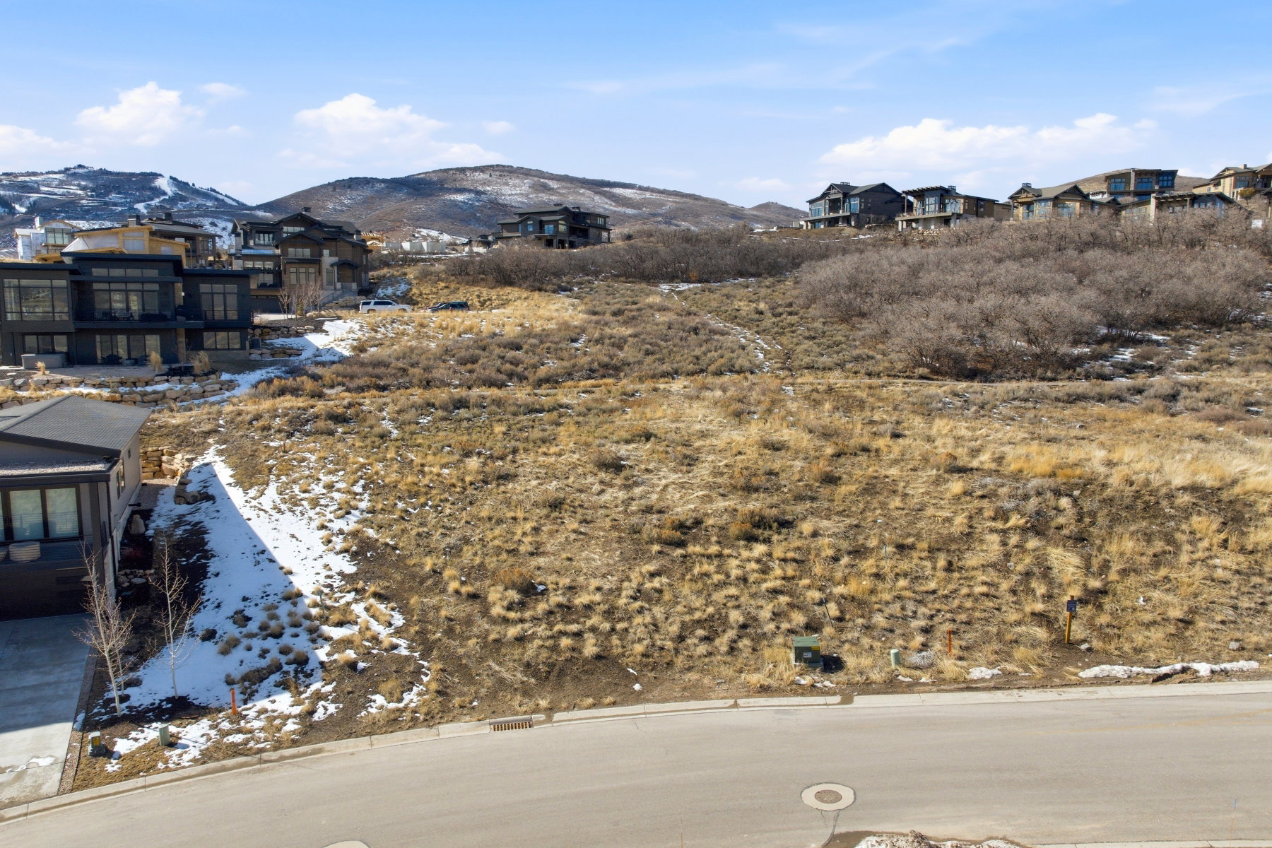 View of mountain backdrop featuring nearby suburban area