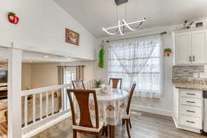 Dining room featuring plenty of natural light, light wood-type flooring, and a chandelier