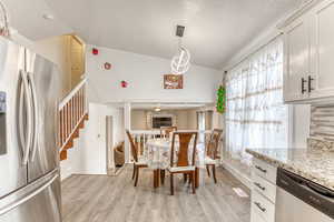 Dining space featuring light wood finished floors and stairway