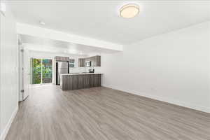 Unfurnished living room with light wood-style floors and recessed lighting