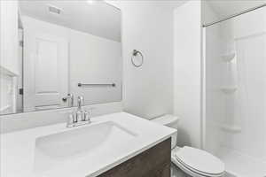 Full bath featuring vanity and a stall shower