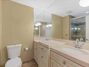Full bathroom featuring double vanity. SECOND LEVEL BATH