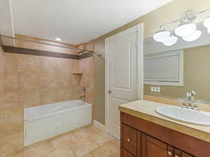 Full bath with vanity and shower / washtub combination