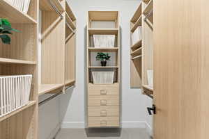 Walk in closet with light carpet