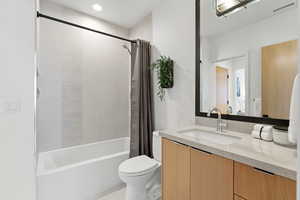 Full bathroom featuring vanity, shower / tub combo, light tile patterned floors, and recessed lighting