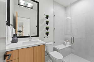 Full bath featuring vanity and a stall shower