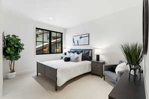 Bedroom with light carpet and baseboards