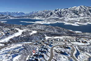 Snowy aerial view with a water and mountain view
