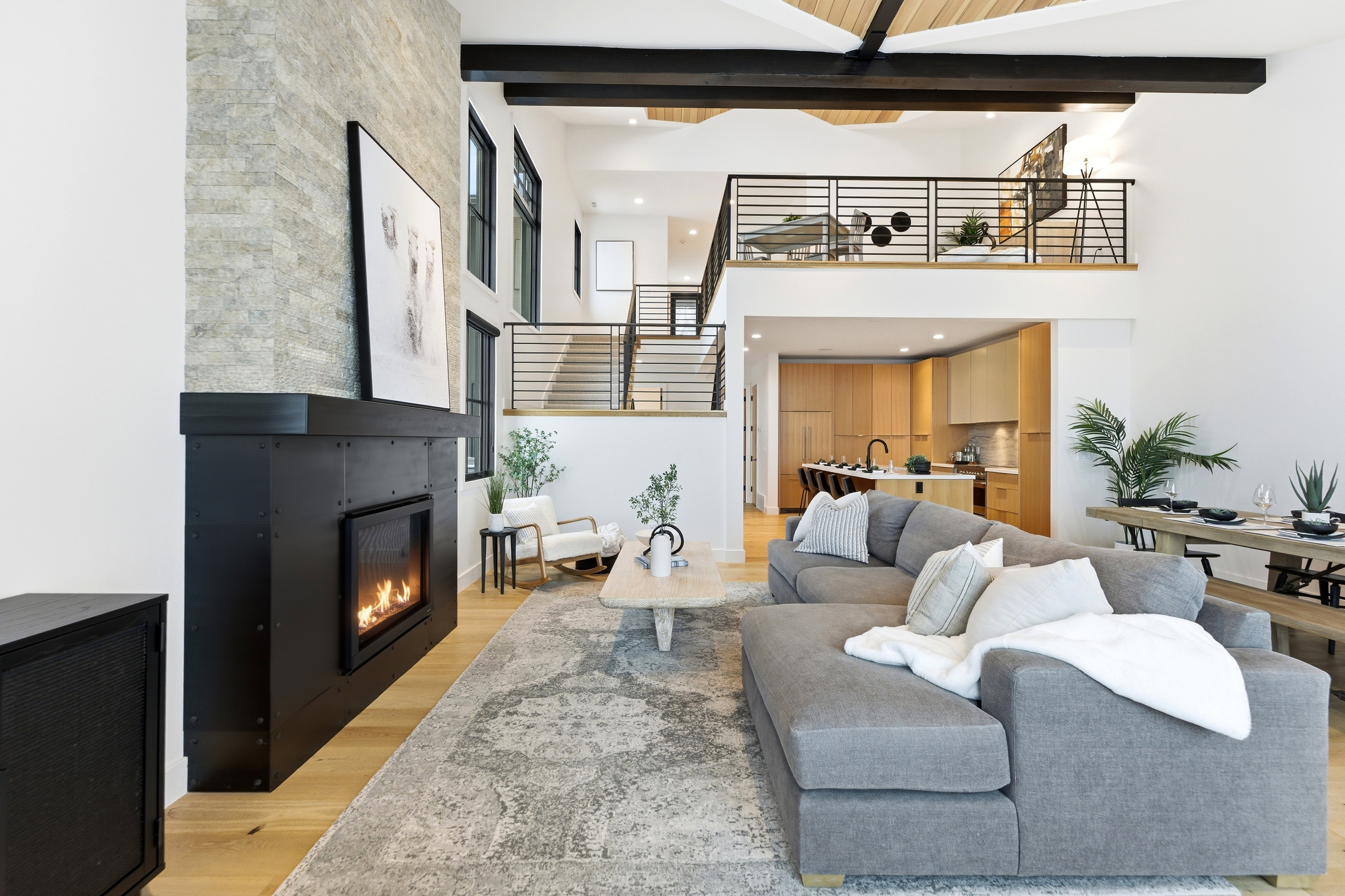 Living room with light wood-style flooring, a fireplace, and recessed lighting