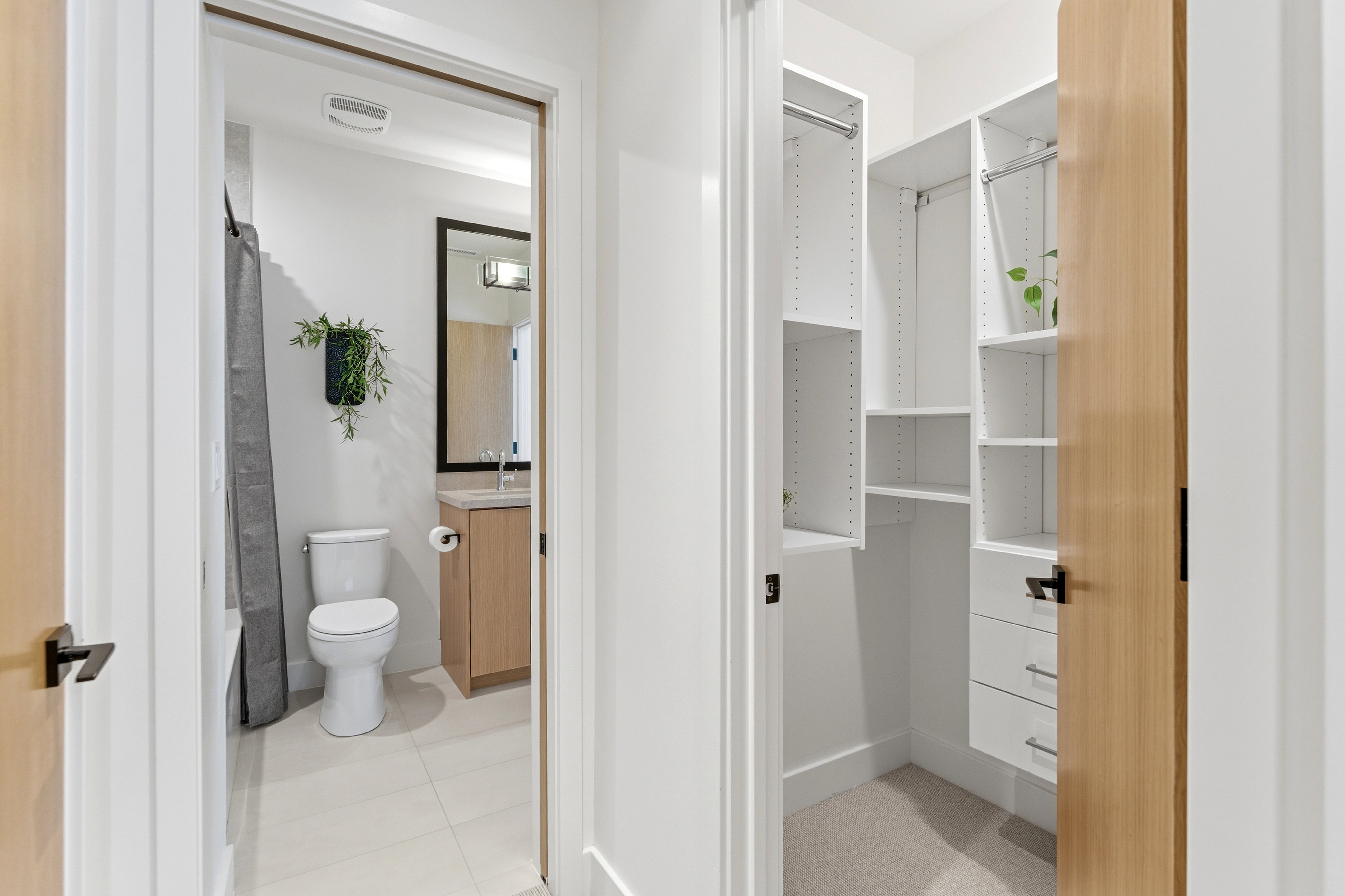 Bathroom featuring vanity, shower / tub combo, and light tile patterned floors