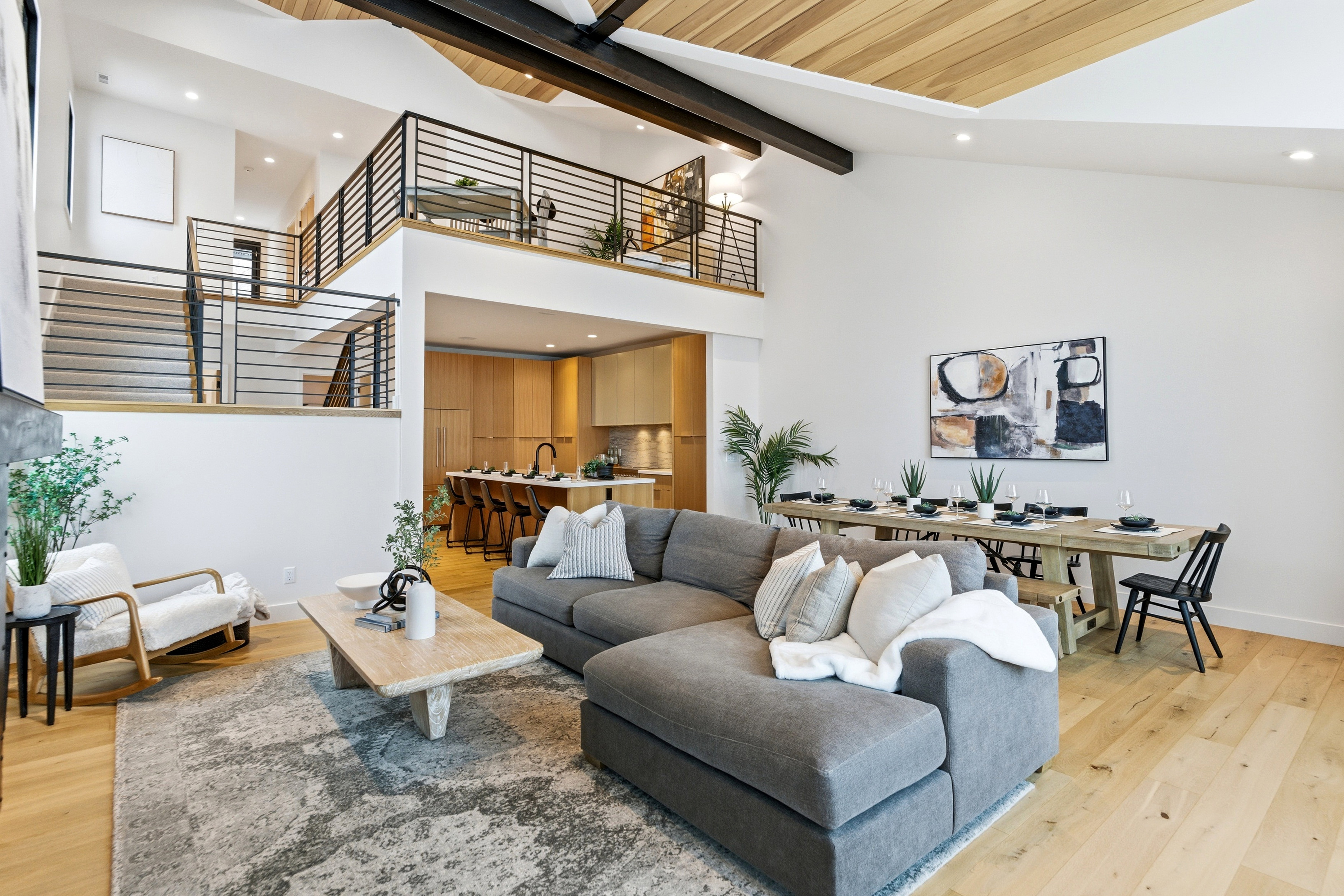 Living area with light wood-style flooring, recessed lighting, and lofted ceiling