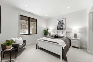 Bedroom with light colored carpet and recessed lighting