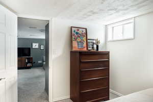 Bedroom featuring light carpet