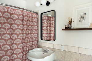 Full bathroom featuring curtained shower