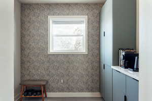 Detailed view of wallpapered walls and a cabinetry