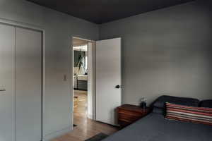 Bedroom featuring light wood flooring and a closet