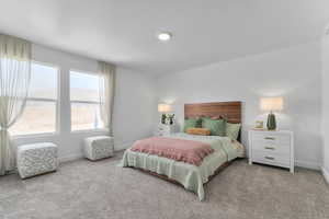 Bedroom featuring carpet floors and baseboards