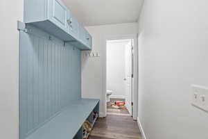 Mudroom with baseboards and dark wood-type flooring
