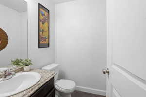 Bathroom featuring vanity and dark wood-style flooring