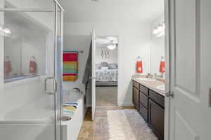 Bathroom with ensuite bath, double vanity, a shower stall, a garden tub, and a ceiling fan