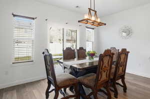 Dining area featuring wood finished floors and hanging lights