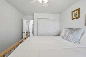 Bedroom with a closet and ceiling fan
