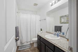 Full bathroom featuring vanity and shower / bathtub combination with curtain