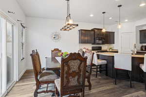 Dining room featuring dark wood finished floors and recessed lighting