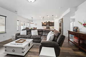 Living room with dark wood-style flooring and recessed lighting