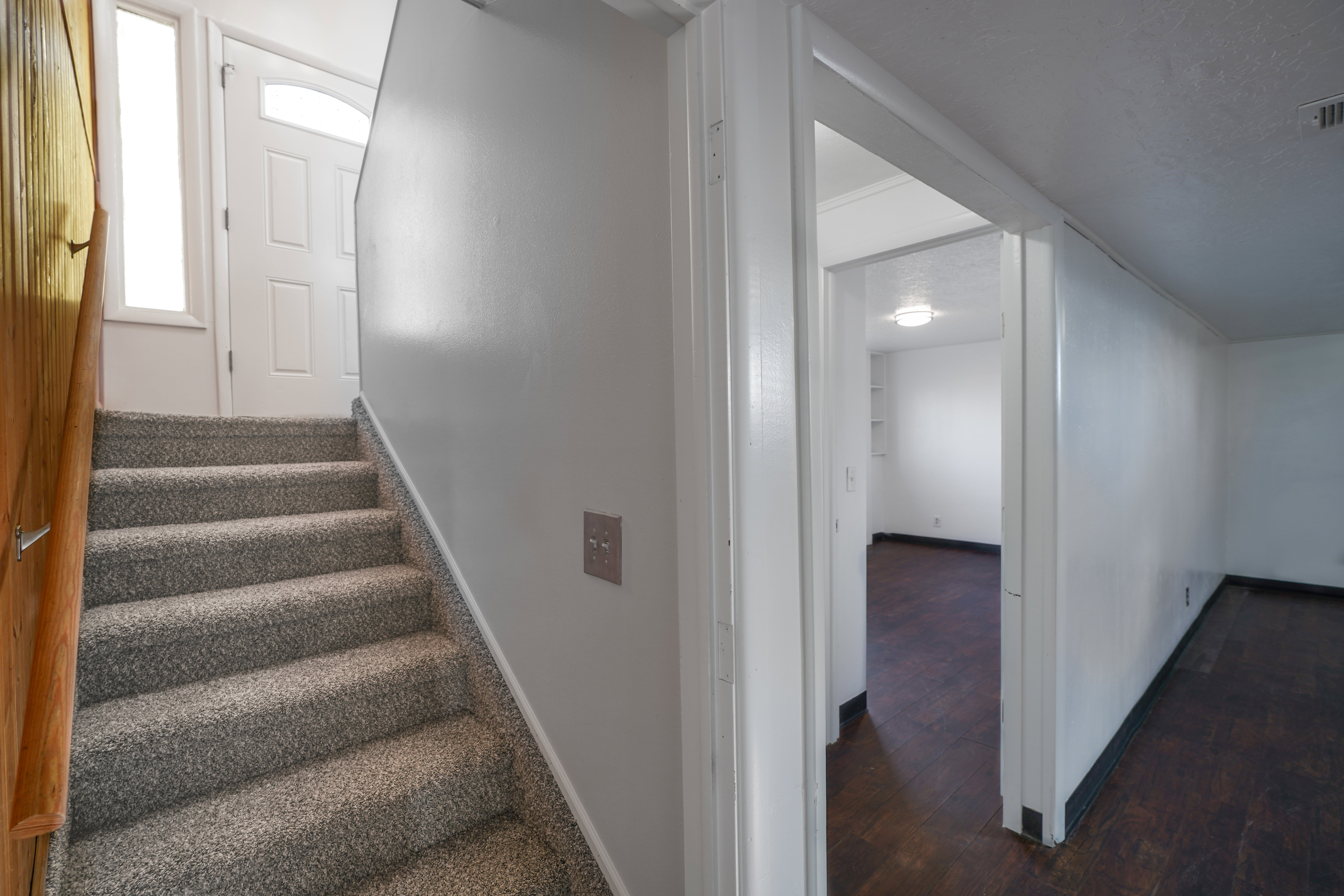 Staircase with baseboards and wood-type flooring