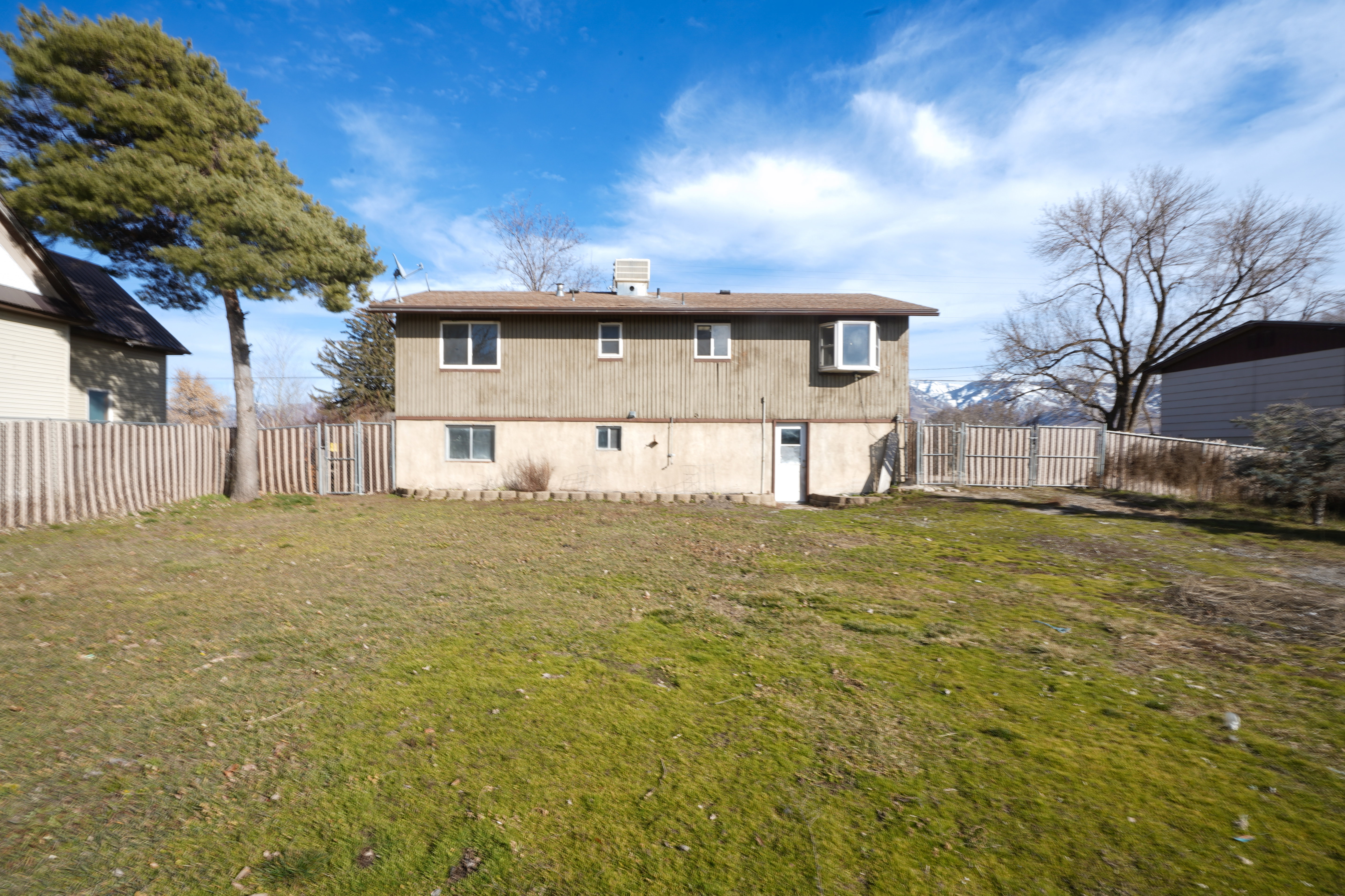 Back of property featuring a fenced backyard