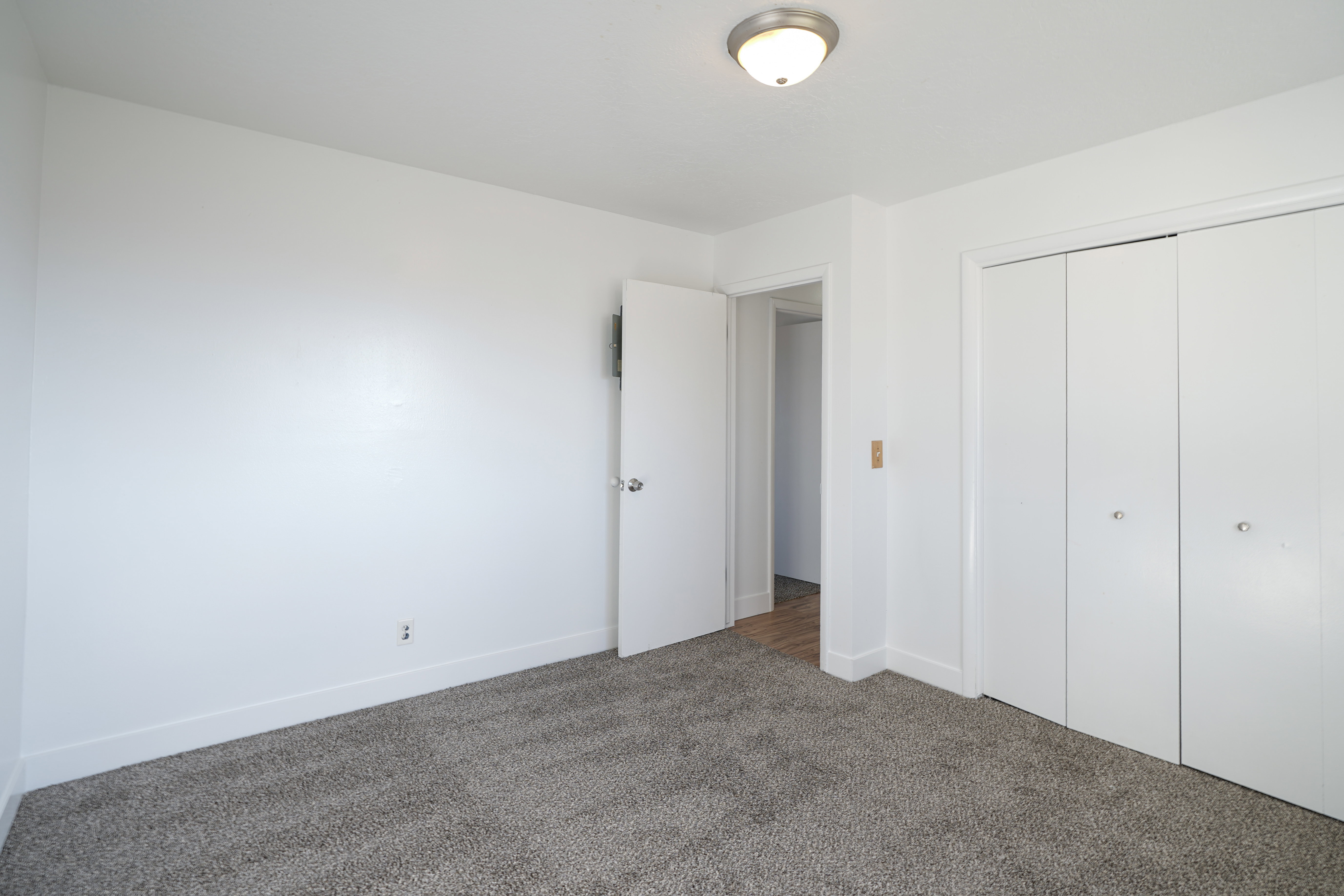 Unfurnished bedroom with dark colored carpet and a closet