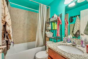 Bathroom with vanity and shower / bath combo with shower curtain
