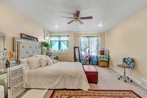 Bedroom with light colored carpet and ceiling fan