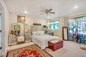 Bedroom with a ceiling fan, recessed lighting, and light carpet