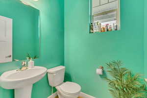 Bathroom featuring toilet and baseboards