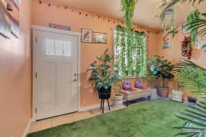 Tiled entrance foyer with baseboards