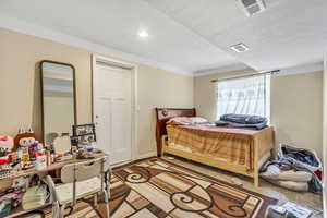 Bedroom with a textured ceiling and recessed lighting