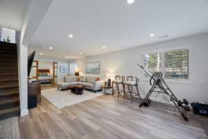 Living area featuring light wood finished floors and recessed lighting