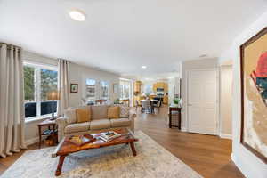 Living area with light wood-type flooring, healthy amount of natural light, and recessed lighting