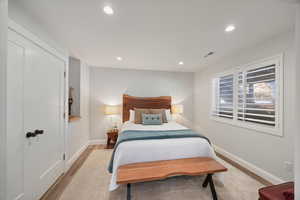 Bedroom with a closet, light wood-style flooring, and recessed lighting