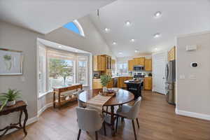 Dining room featuring vaulted ceiling and light wood-type flooring